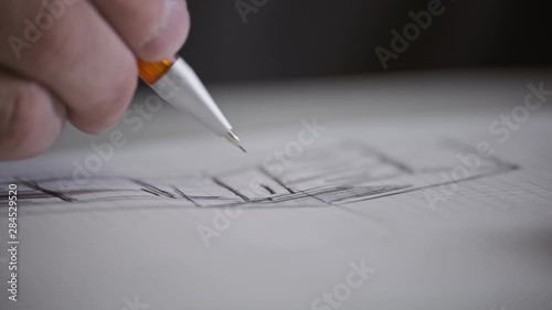 Male architect at work. Architect Hands. Pencil in hand of architect. Engineer works with drawings. Artist drawing with pencil. Close-up view photo