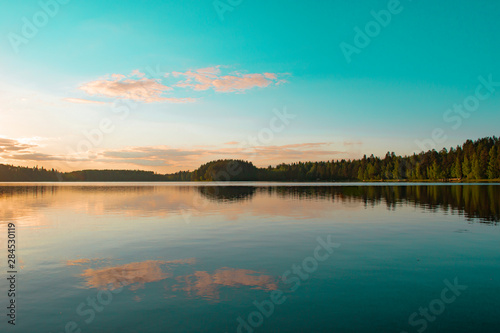 Landscape with lake, blue sky, beautiful clouds and reflection in the water