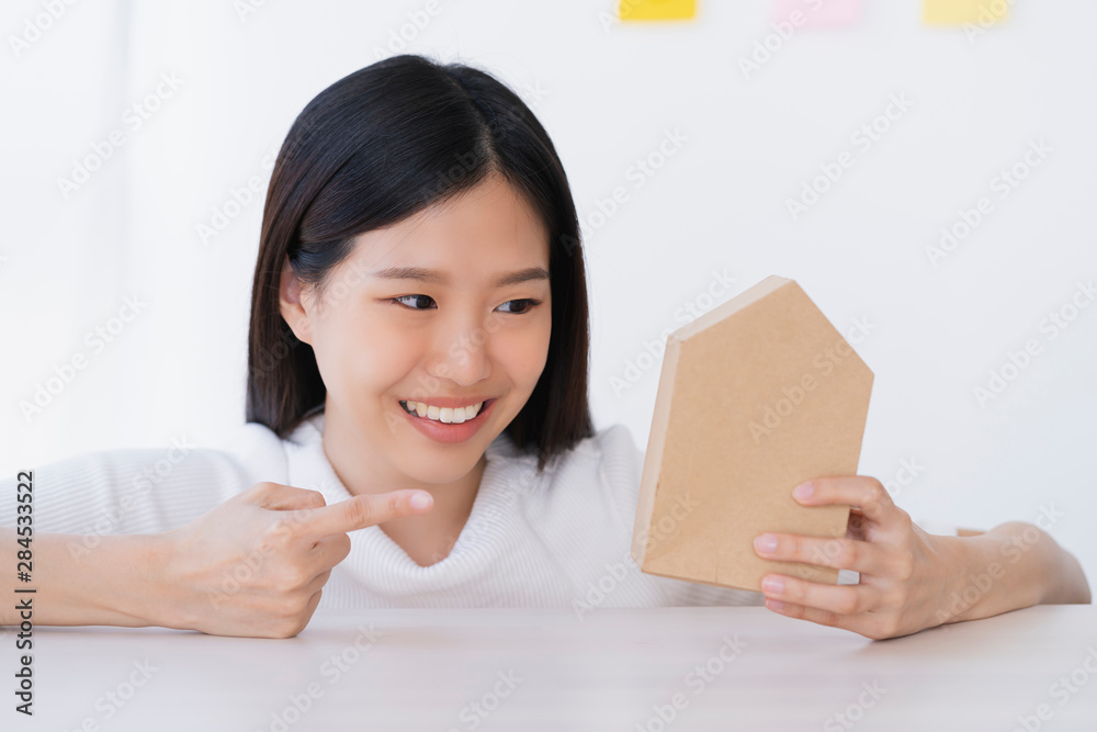 smart beautiful asian woman hand hold and pick house paper model saving and insurance business ideas concept smart beautiful asian woman hand hold and pick house paper model saving and insurance business ideas concept