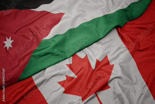 waving colorful flag of canada and national flag of jordan.