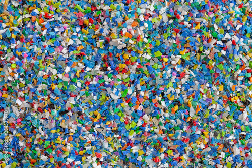 Crushed plastic granules for recycling.  Plastic crusher. Recycled plastic with mixed colors. The concept of recycled plastic used