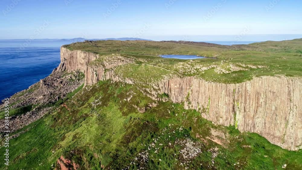 Fair Head or Benmore big cliff and headland near Ballycastle. Atlantic coast, County Antrim, Northern Ireland, UK. Aerial 4K video in sunset light with far view of Scotland and then Rathlin Island Fair Head or Benmore big cliff and headland near Ballycastle. Atlantic coast, County Antrim, Northern Ireland, UK. Aerial 4K video in sunset light with far view of Scotland and then Rathlin Island