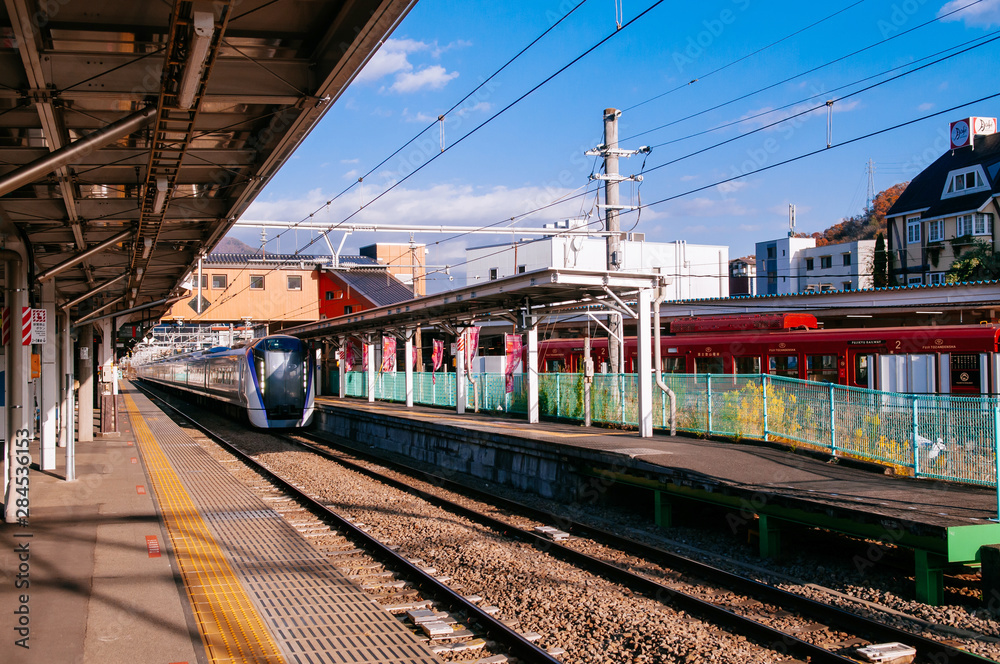 Japan Azusa Express train at Otsuki station platform under warm sunlight in winter