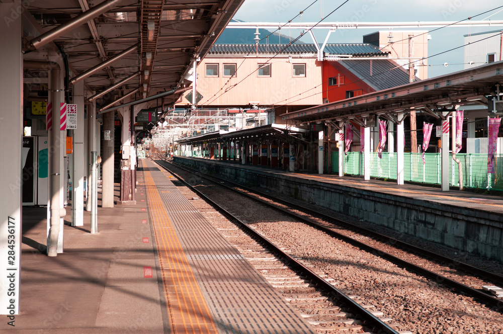 Naklejka premium Empty Japan Otsuki train station platform under sunlight in winter