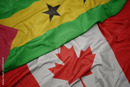 waving colorful flag of canada and national flag of sao tome and principe.