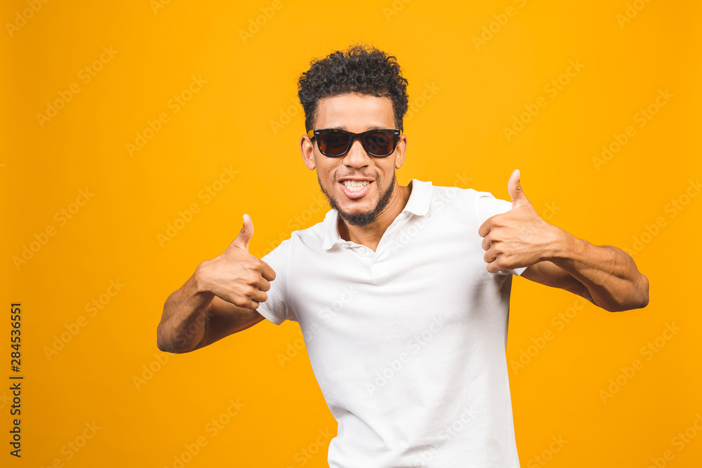 Cool afro american man wearing sunglasses over isolated background, having successful idea. Exited and happy. Number one. Thumbs up. Cool afro american man wearing sunglasses over isolated background, having successful idea. Exited and happy. Number one. Thumbs up.