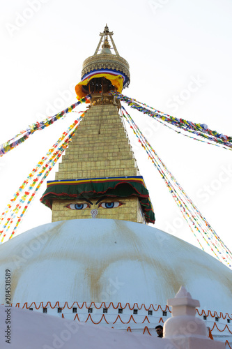 golden roof of the Stupa of Bodnath in Kathmandu with Tibetan flags