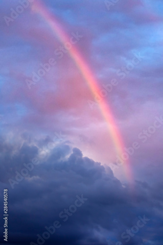 cloudy blue sky with clouds and beautiful rainbow 