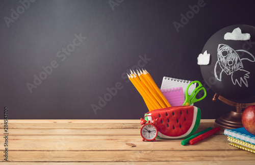 Obraz na plátně Back to school creative background with watermelon pencil case and school supplies on wooden table