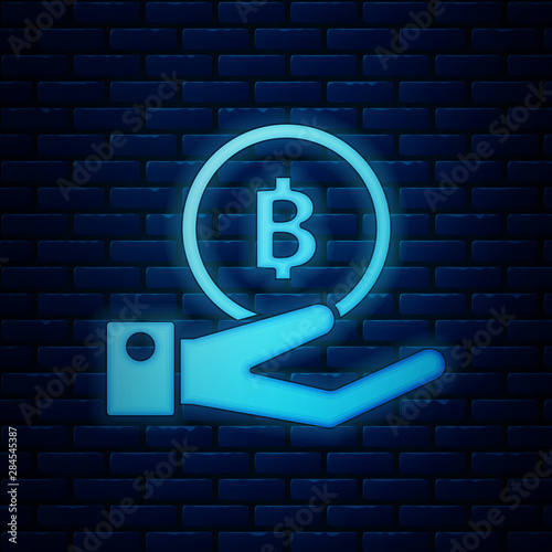 Glowing neon Hand holding Bitcoin icon isolated on brick wall background. Blockchain technology, digital money market, cryptocoin wallet. Vector Illustration