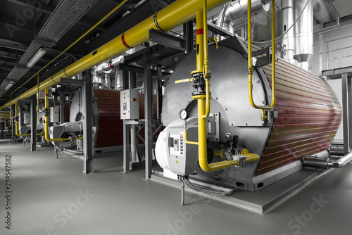 Modern industrial gas boiler room equiped for heating process. Heating gas boilers, pipelines, valves