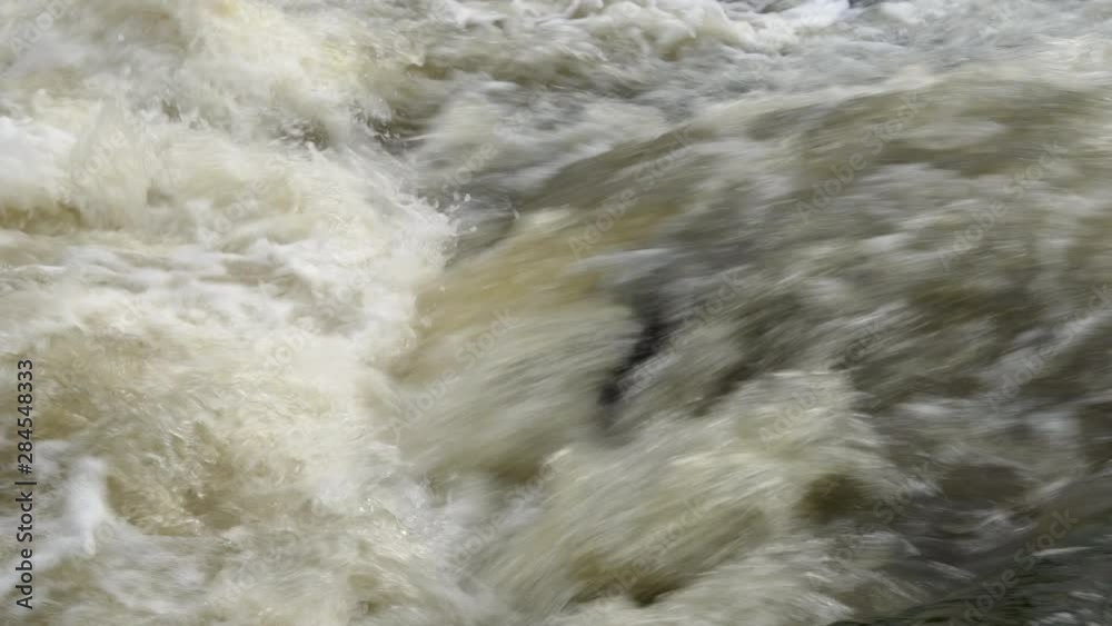 Bubbles coming out from the rushing water in Finland river during the autumn season