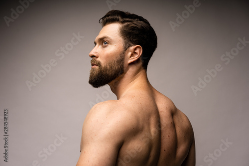 perfect fit man from the back in the white background. Bearded caucasian man.
