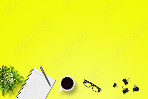 Office desk or education desk with pen, Notebook, paper clip, glasses, Flower vase, coffee, supplies with copy space background, Top view/flat lay 