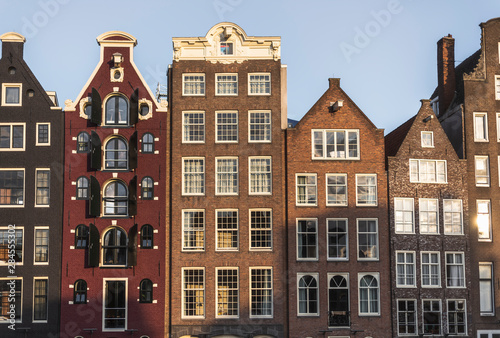 Historical buildings of Damrak in the sunset light.