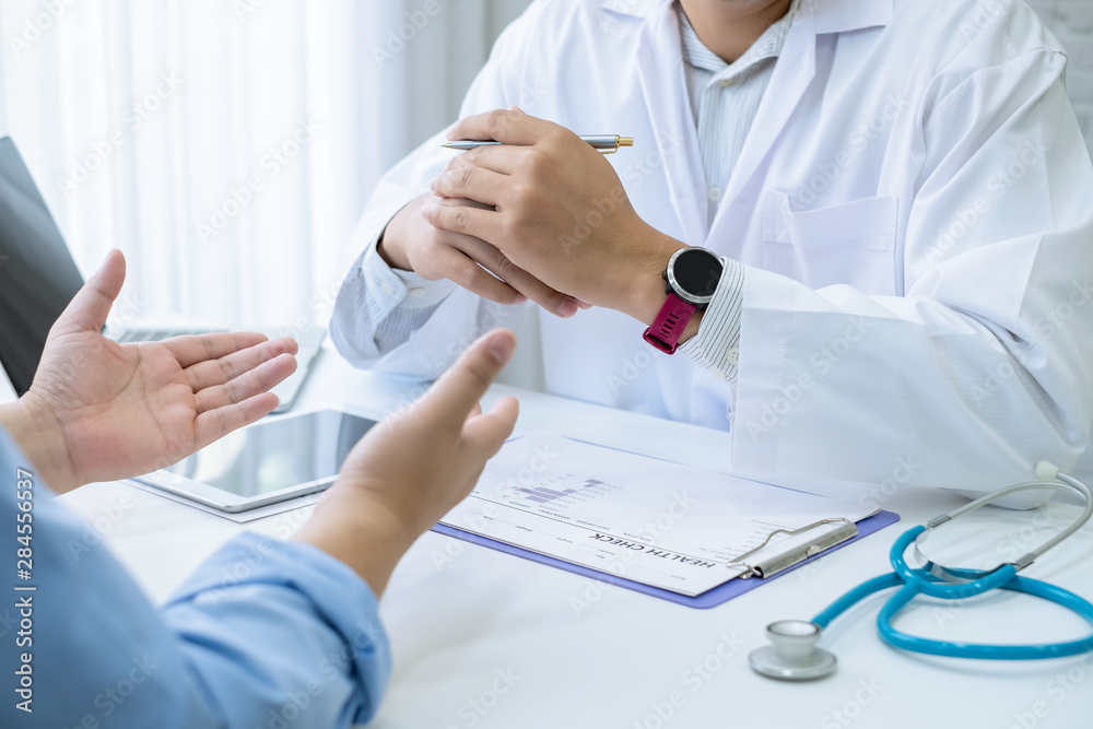 Doctor gave advice and talked to the male patient at work. Doctor gave advice and talked to the male patient at work.