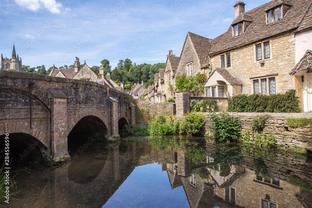 Combe, Great Britain - July 07. 2019: Typicla architecture style of South England, the Cotswold village of Castle Combe, England