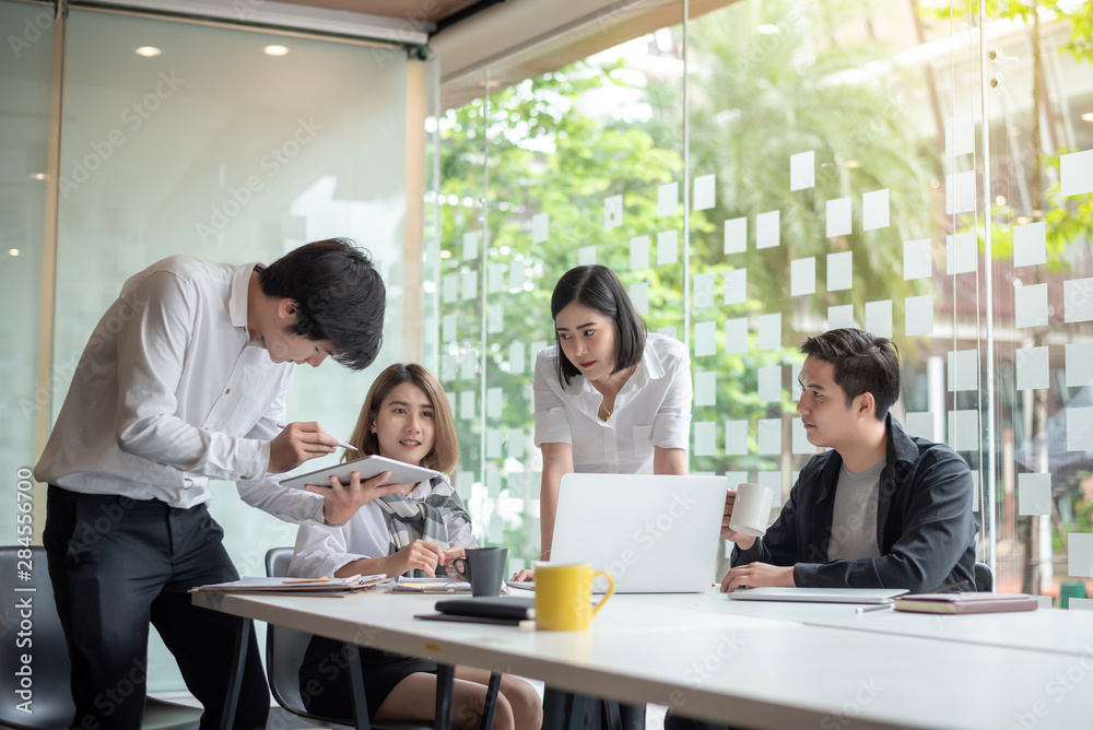 Group of young business people brainstorming at a meeting starting a new business.