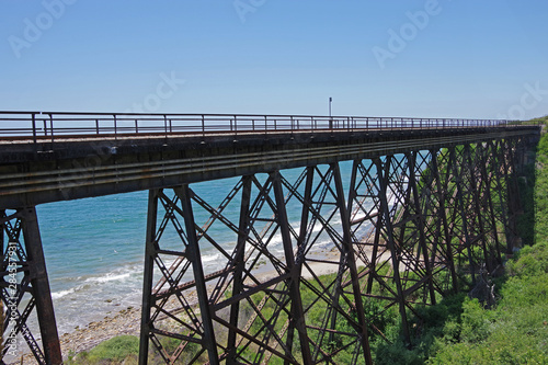 An old high railway bridge construction crossing a canyon along the California coastline