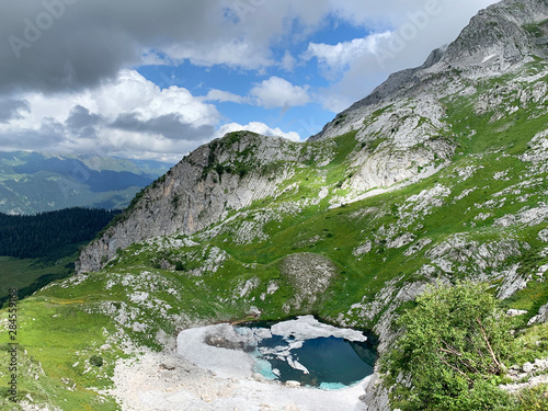 Abkhazia, lake Dzou in the mountains in summer in cloudy weather photo