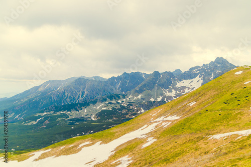 Fototapeta Naklejka Na Ścianę i Meble -  Beautiful panorama of green mountains hills with snow from Kars to Kasprowy Wierch in summer.