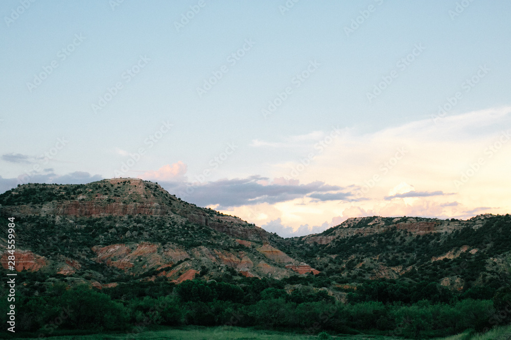 palo duro canyon at sunset, clouds and moon in sky, dessert horizon palo duro canyon at sunset, clouds and moon in sky, dessert horizon
