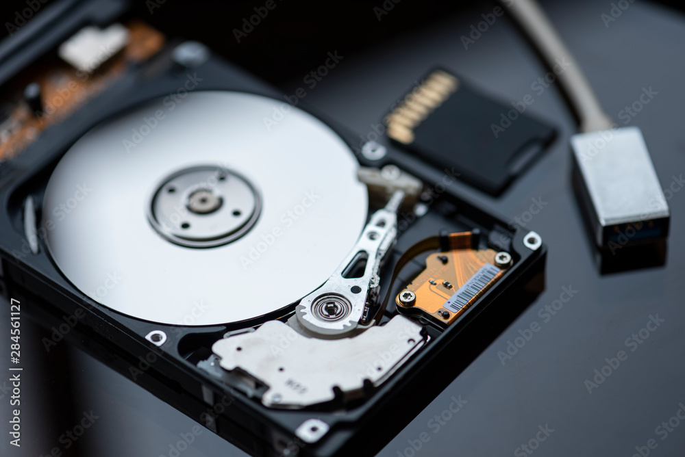 Broken hard disk and memory card on the desk. Broken hard disk and memory card on the desk.