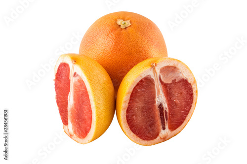 grapefruit - one whole and two halves on a white background