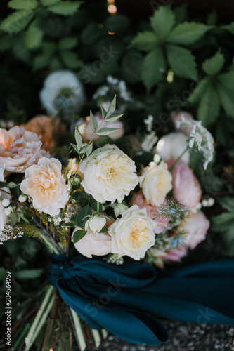 White, pink, and peach peony flower wedding bouquet with blue silk ribbon, modern wedding flowers