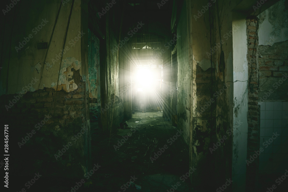 Empty corridor toward sunlight in a spooky house