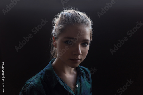 Tableau sur toile young pretty sensual girl in checkered green shirt posing on black background ti