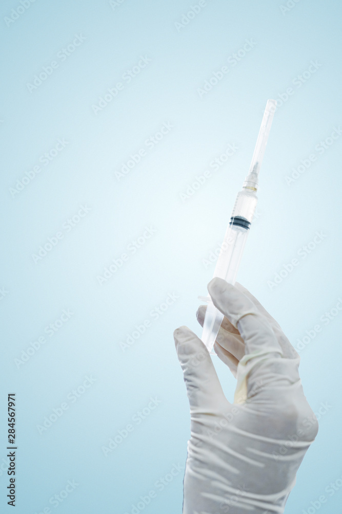 Female doctor hands holding an injection needle Female doctor hands holding an injection needle