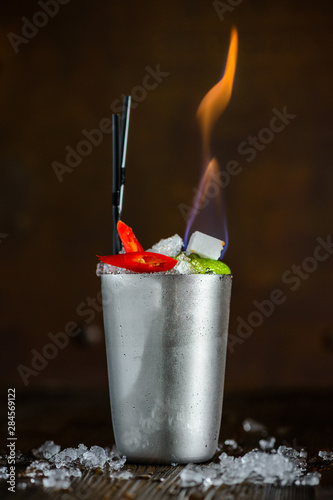 Alcohol cocktail set on fire and it burns