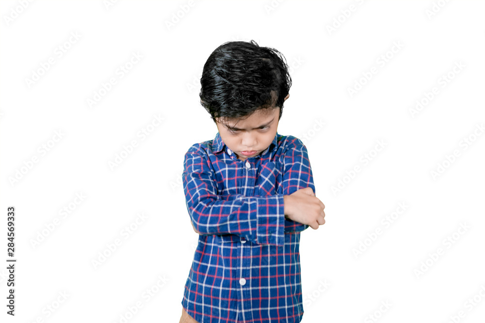 Little boy standing with cranky expression Little boy standing with cranky expression