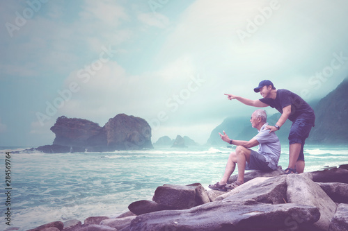 Old man and his son enjoying a Papuma beach view