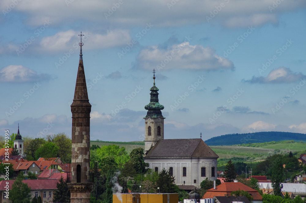 Big Turkish Minaret and church bell tower in Eger cityscape, Hungary