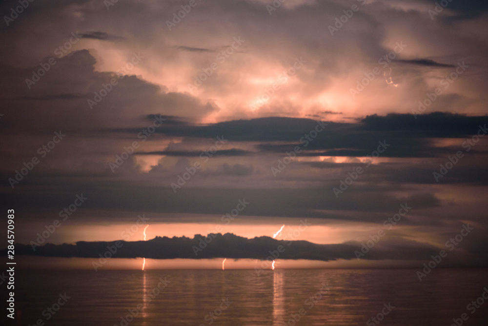 Beautiful summer storm over Black Sea - dramatic scenery, lightning strikes, fire in the sky