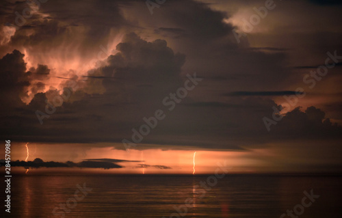 Beautiful summer storm over Black Sea - dramatic scenery, lightning strikes, fire in the sky © photoenthusiast
