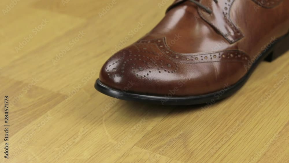 Slider shot, brown classic men's shoes on a wooden background. Copy space. Slider shot, brown classic men's shoes on a wooden background. Copy space.