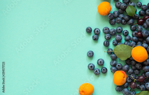background with blueberries and apricots light tree texture. view from above