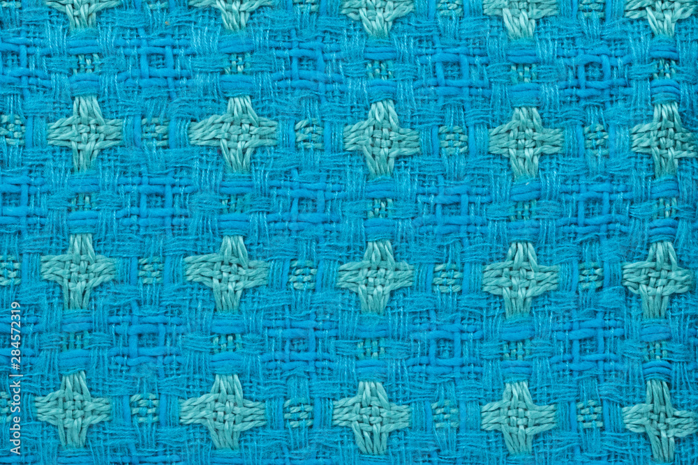 Fototapeta premium Background in the form of material from wool blue and green with a pattern, top view