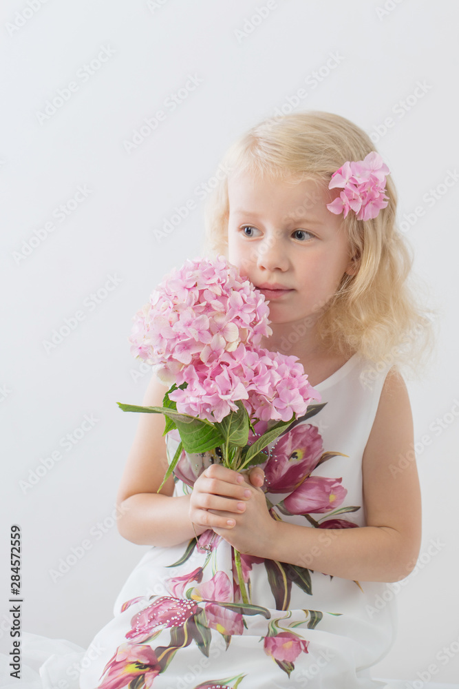 beautiful little blonde girls with pink flowers on white background beautiful little blonde girls with pink flowers on white background