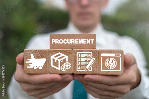 Man arranging wooden blocks with supply chain and retail logistics icons. Procurement Management Industry concept. photo