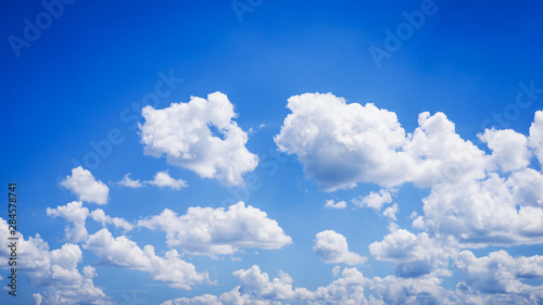 Wide photo of fluffy clouds in deep-blue sky © Vitalii
