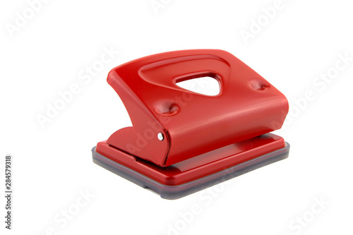 Red office paper hole puncher, isolated on white background photo