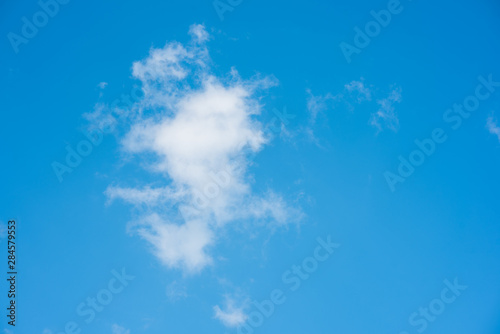 Blue sky with white cloud as wallpaper or background. Natural cover.