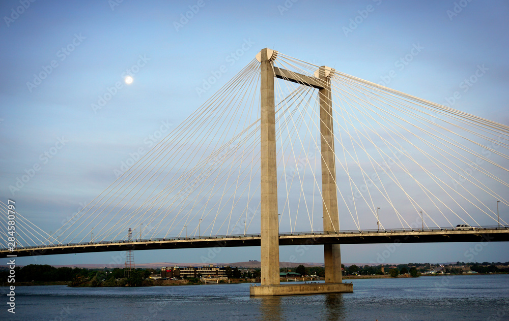 Cable susoension bridge over Columbia river at dawn with moon in sky Cable susoension bridge over Columbia river at dawn with moon in sky