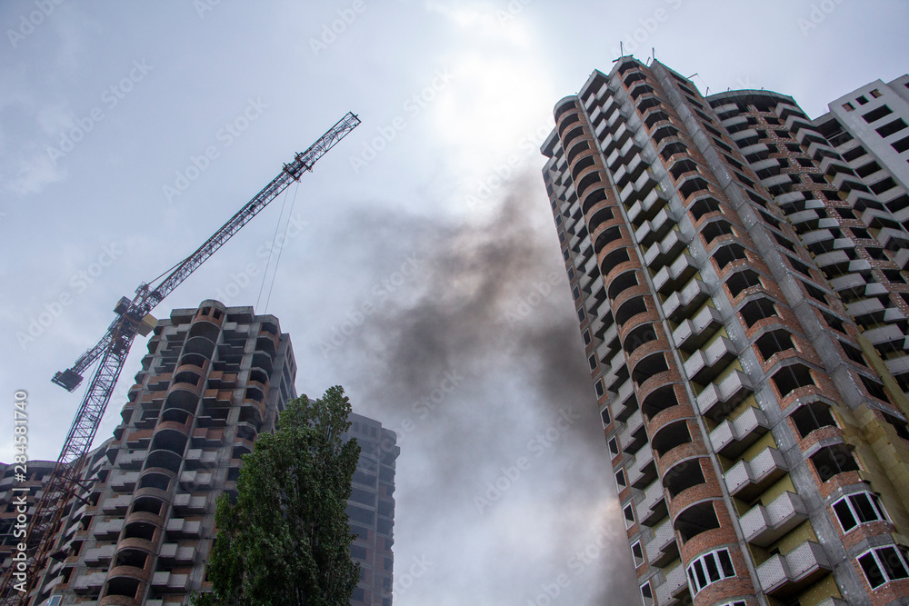 Fototapeta premium Fire At a construction site, unfinished multi-storey reinforced concrete building