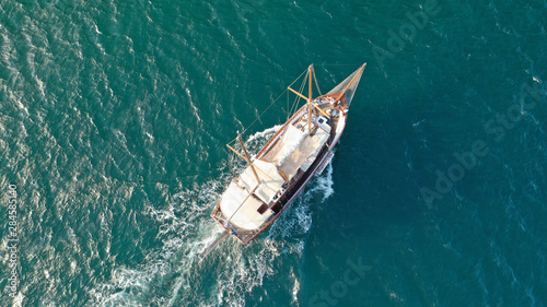 Aerial drone view of small vintage wooden schooner sailing in Balearic islands © aerial-drone