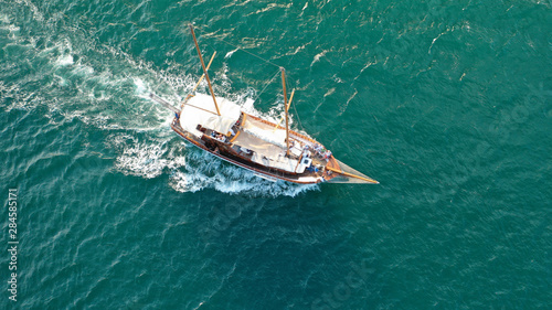 Aerial drone view of small vintage wooden schooner sailing in Balearic islands © aerial-drone